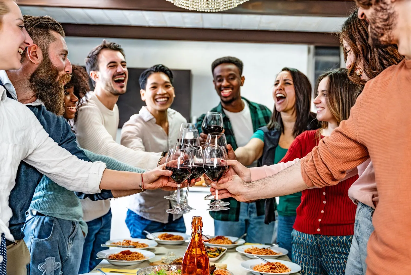 Team raising a toast over a shared dinner